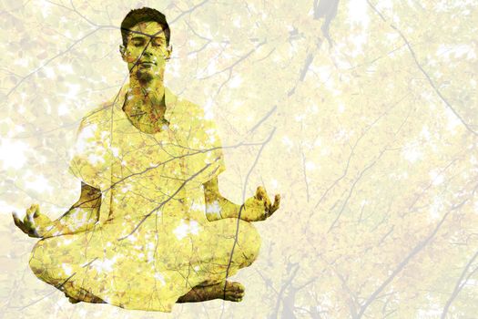 Handsome man in white meditating in lotus pose against branches and autumnal leaves