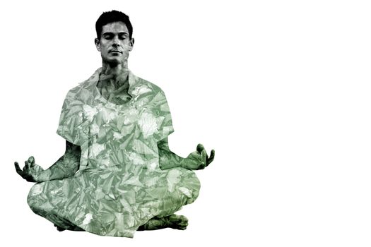 Handsome man in white meditating in lotus pose against detail shot of dry leaves