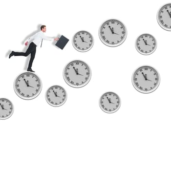 Businessman walking with his briefcase against clocks