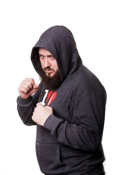 Boxer athlete with a huge beard hooded worth hands clenched into fists. Isolated on white background