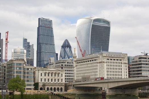 LONDON, UK - JUNE 23: The Walkie-Talkie, Cheese Grater, and Gherkin, seen from London Bridge. June 23, 2015 in London.