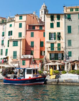 12th century Italian town, Portovenere Harbor promenade along the harbor is a pedestrian only zone. The promenade is lined with tall colorful houses, seafood restaurants, and bars fishing boats,