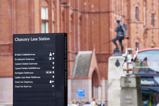 LONDON, UK - JUNE 23: Chancery Lane Station direction sign with war memorial in the background. June 23, 2015 in London.