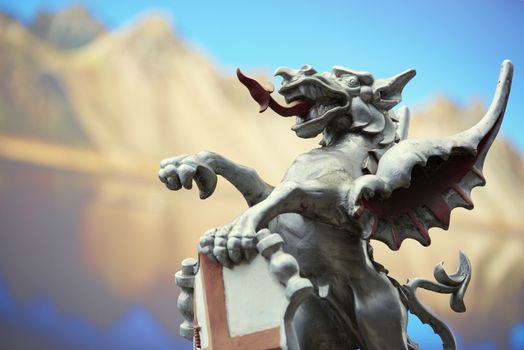 LONDON, UK - JUNE 23: Detail of the City of London dragon with photograph of mountains in the background. June 23, 2015 in London.