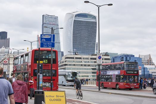 LONDON, UK - JUNE 23: Traffic on London Bridge, with The Walkie-Talkie, Cheese Grater, and Gherkin in the background. June 23, 2015 in London.