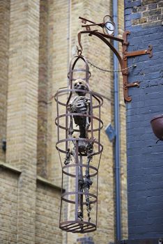LONDON, UK - JUNE 23: Replica of skeleton in cage at the entrance to The Clink prison museum, which exhibits medieval torture tools. June 23, 2015 in London.