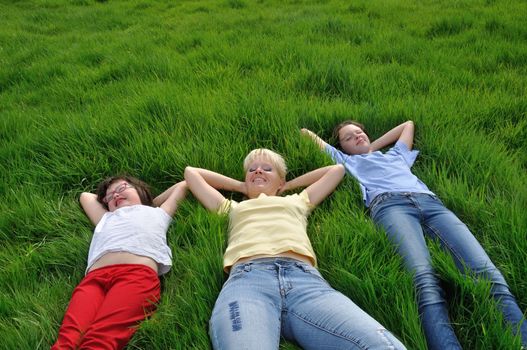 Mother and daughters making a nap on the grass