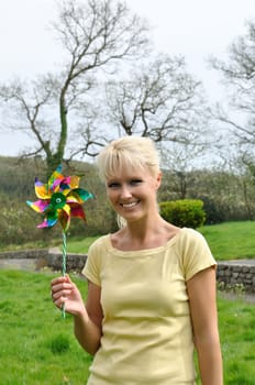 Portrait of blond woman with coloured pinwheel
