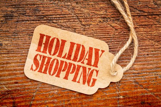 Holiday shopping  sign a paper price tag against rustic red painted barn wood