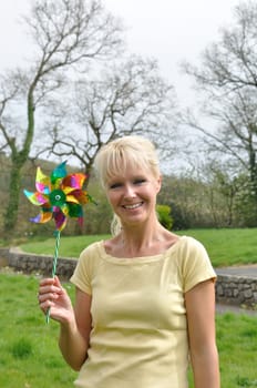 Portrait of blond woman with coloured pinwheel