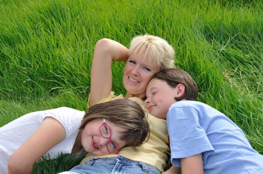 Mother and daughters making a nap on the grass