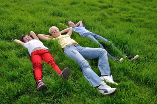 Mother and daughters making a nap on the grass