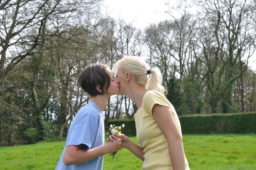 Daughter offering flowers to her mother