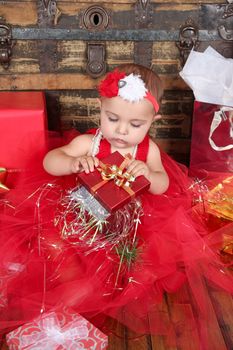 Brunette christmas baby wearing a red dress