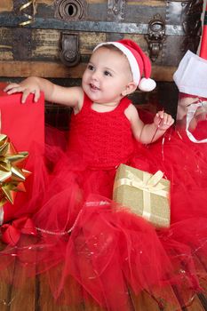 Brunette christmas baby wearing a red dress
