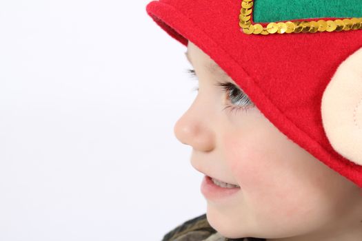 Young boy wearing a christmas elf hat