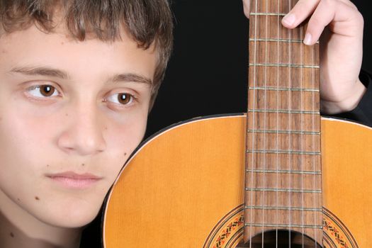 Close up of teen boy with his guitar