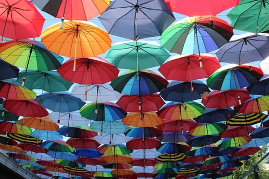Soaring in the sky multi-colored umbrellas.