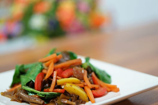 Stir-fried vegetarian noodles with vegetable several colors in sweet soy sauce.                             