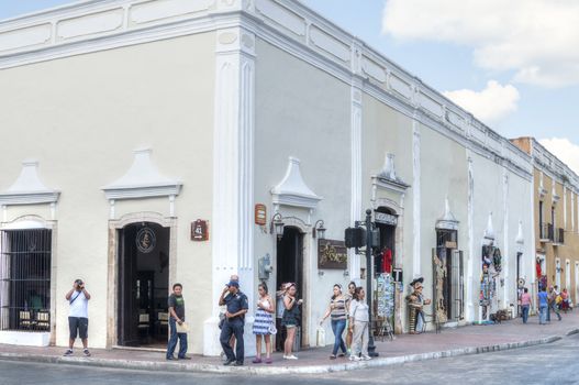 VALLADOLID, MEXICO - JANUARY 20, 2015: Tourists enjoy shopping and viewing old historical architecture in the tranquil city of Valladolid, Mexico