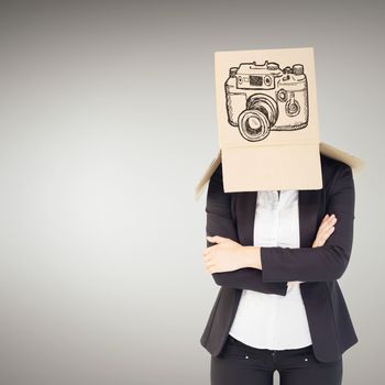 Businesswoman lifting box off head against grey vignette
