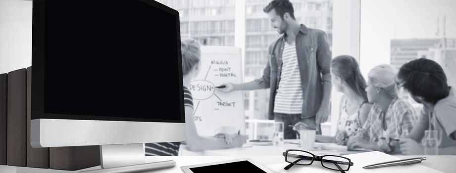 Computer screen against casual business people in office at presentation