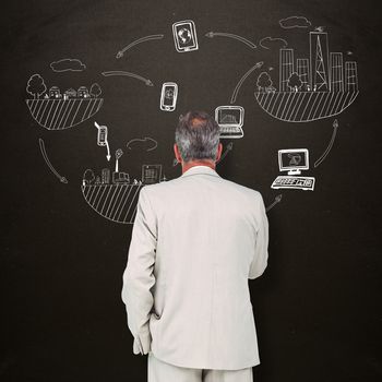 Thinking businessman against blackboard