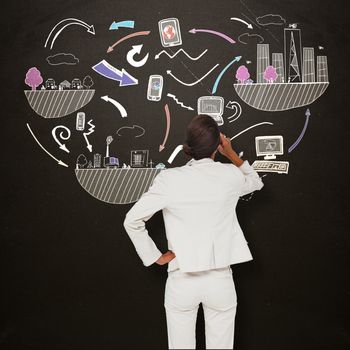 Thinking businesswoman against blackboard