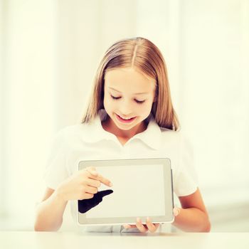 education, school, technology and internet concept - little student girl with tablet pc at school