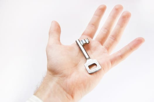 Key conceptual image. Man holds the key.