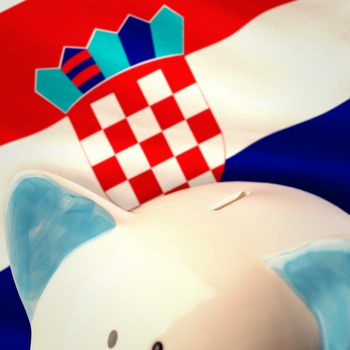 Piggy bank against digitally generated croatia national flag