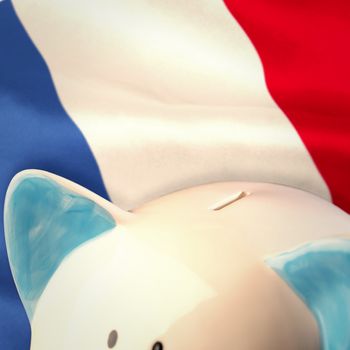 Piggy bank against digitally generated france national flag