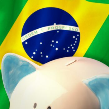 Piggy bank against digitally generated brazilian national flag