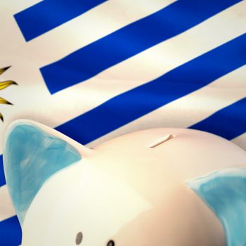 Piggy bank against digitally generated uruguay national flag