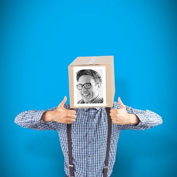Businessman with photo box on head against blue background with vignette