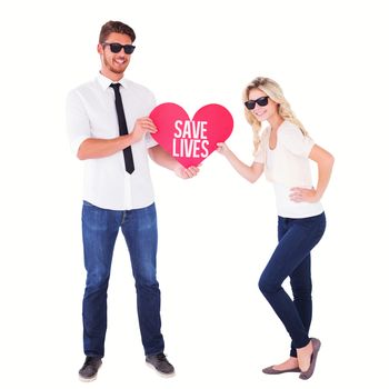 Cool young couple holding red heart against save lives