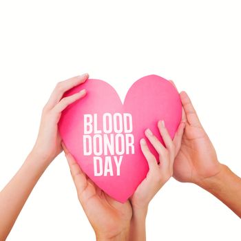 Couple holding a paper heart against blood donor day