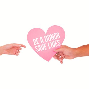 Couple passing a paper heart against be a donor save lives
