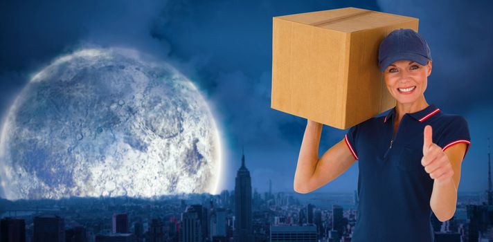 Happy delivery woman holding cardboard box showing thumbs up against large moon over city