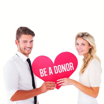 Attractive young couple holding red heart against be a donor
