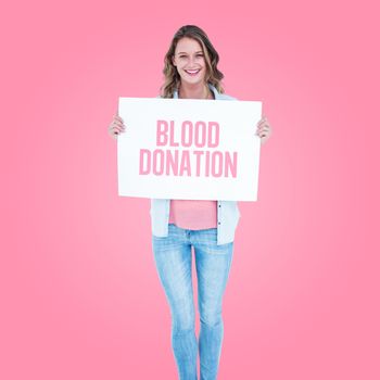 Woman holding poster  against pink