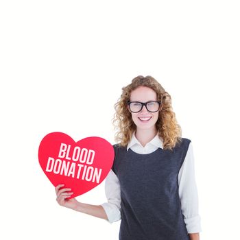 Geeky hipster holding heart card against blood donation