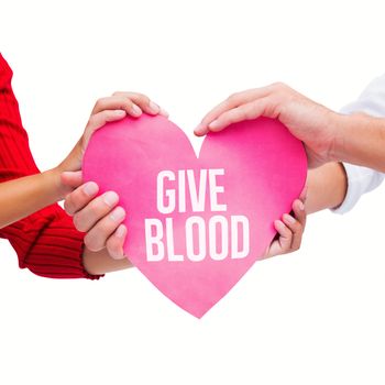 Couple holding a heart against give blood