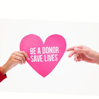 Woman passing man pink heart against be a donor save lives