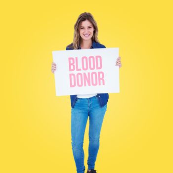 Woman holding poster  against yellow vignette