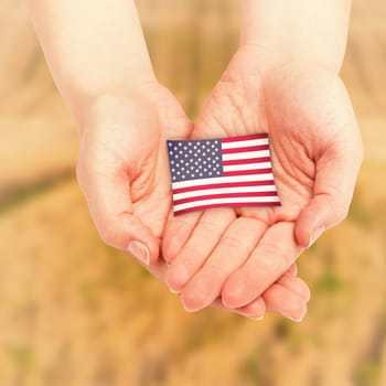 Hands presenting against rural fields