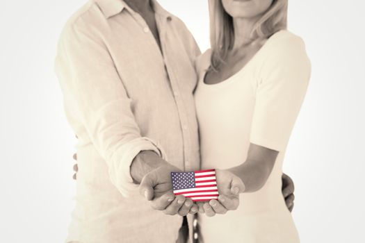 Happy couple holding their hands out against usa national flag