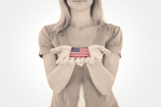 Happy blonde holding our her hands against usa national flag