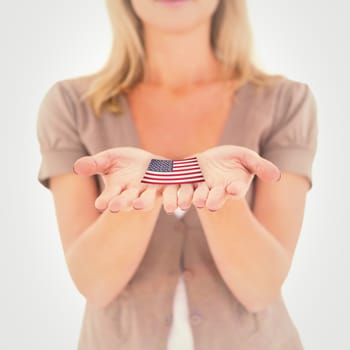 Happy blonde holding our her hands against usa national flag