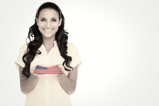 Pretty brunette holding out hands against usa national flag